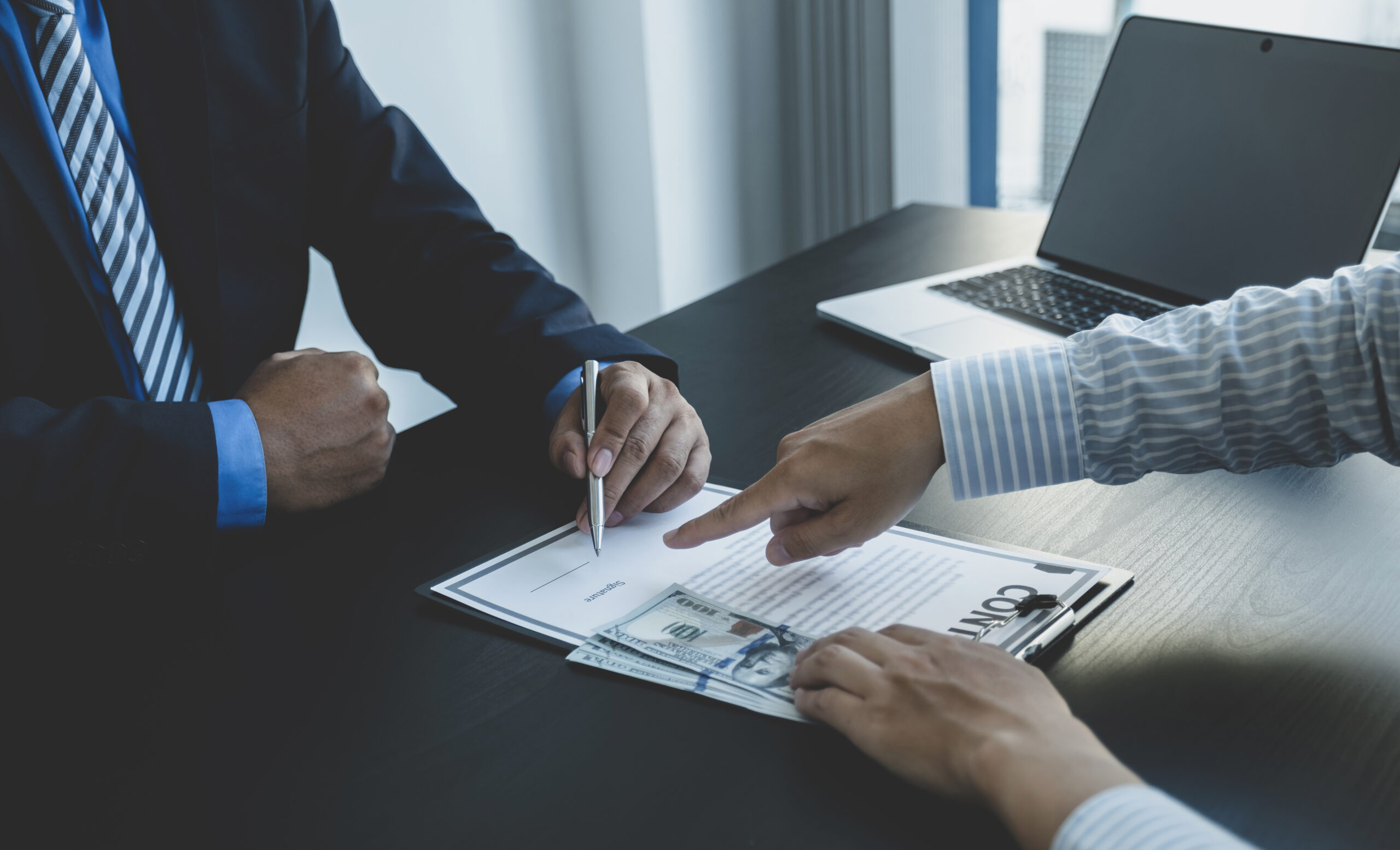 Government officials hand sign the contract for receiving bribe money from businessman, the concept of corruption and anti-bribery.